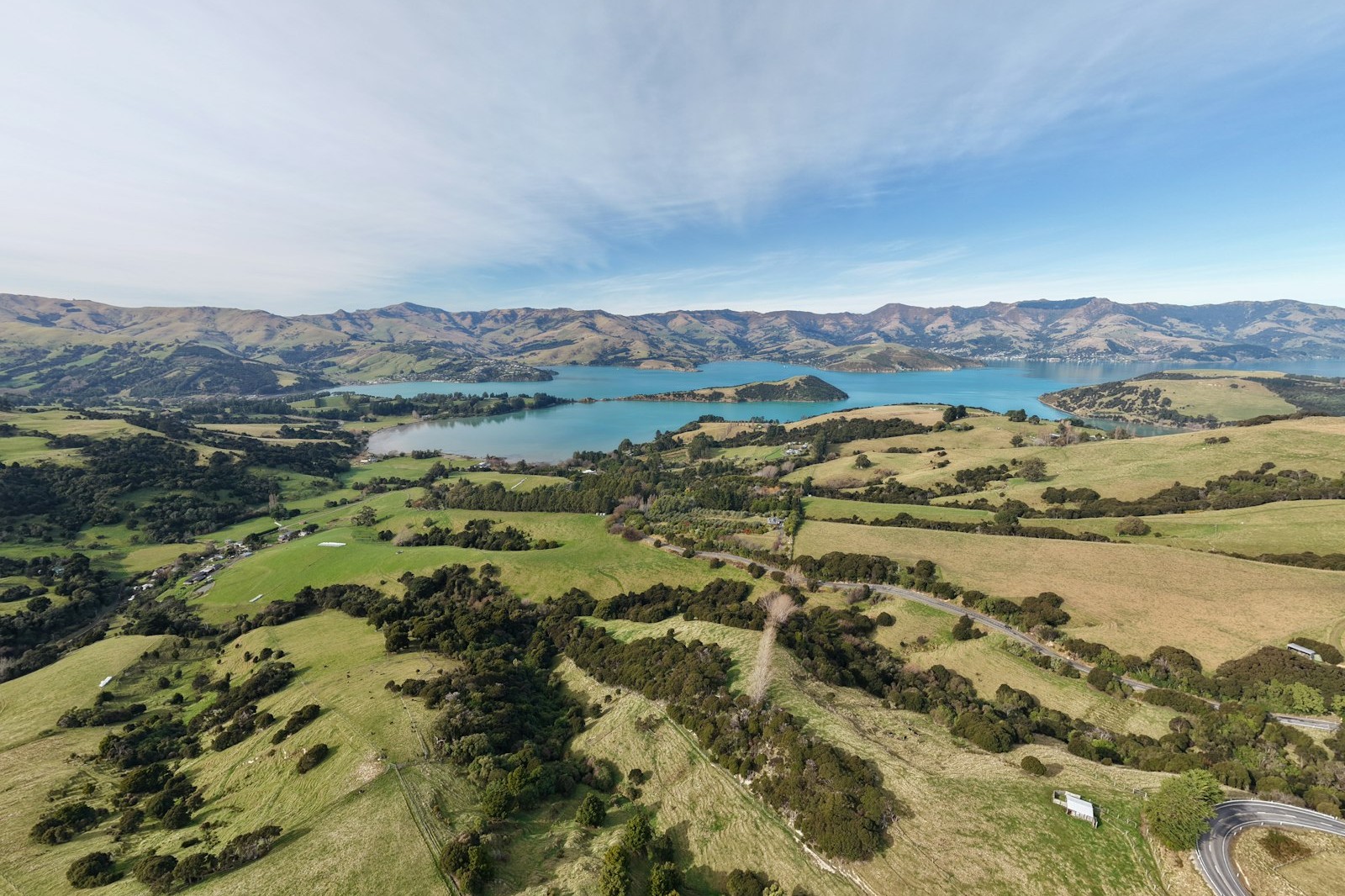 Rolling green hills above a blue bay