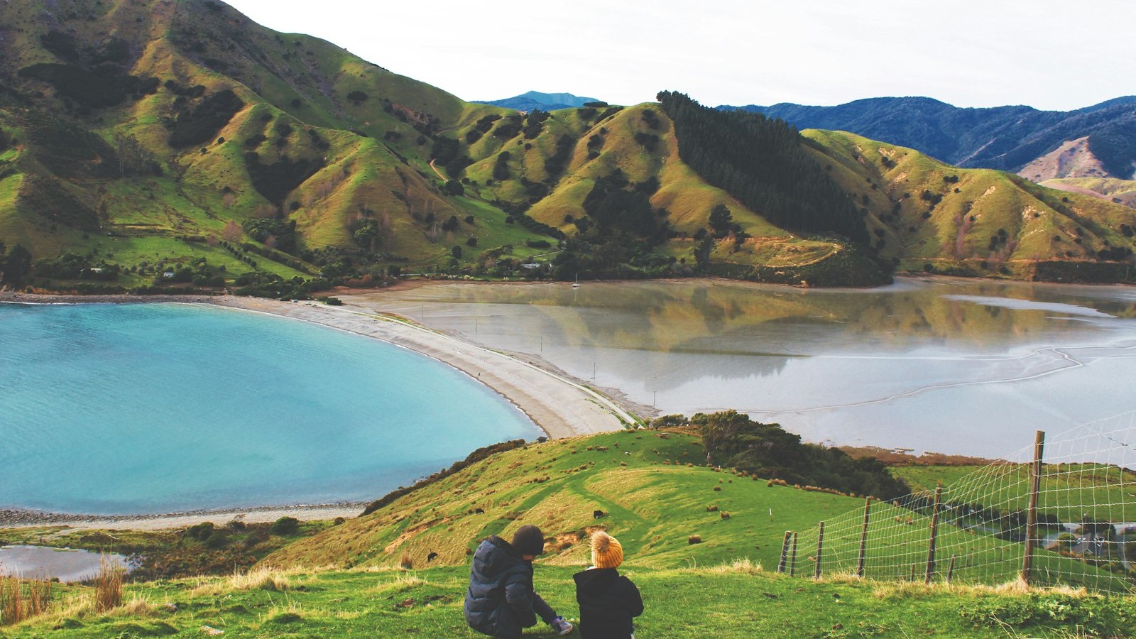 Green hills beside a lake and bay near Nelson