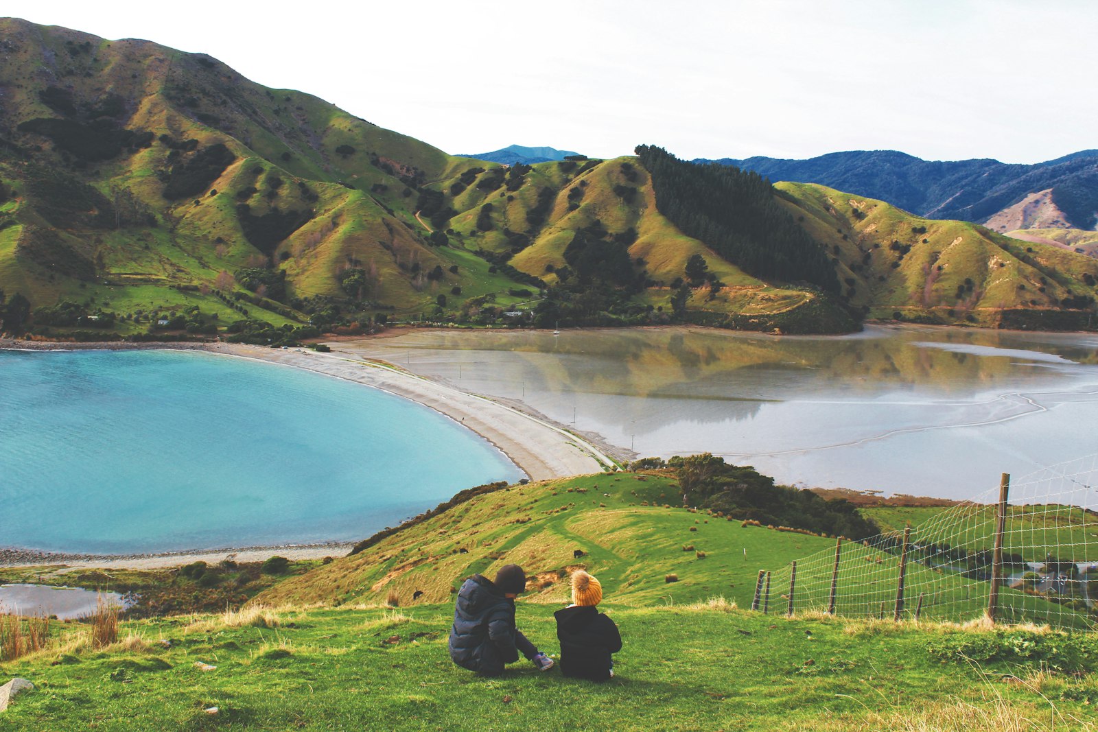 Green hills beside a lake and bay near Nelson