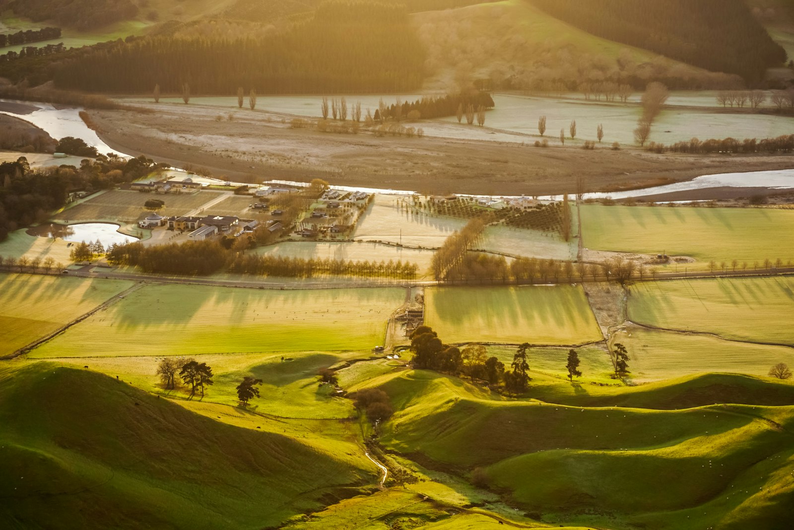 Aerial view of farmland with a river running through it